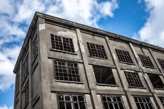 Recession Image Of A Derelict Factory Against A Blue Sky