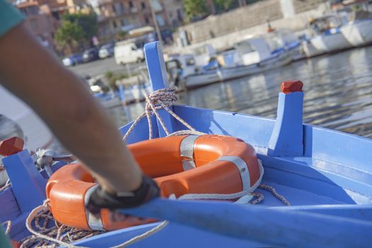 Rowing boat detail with life buoy.