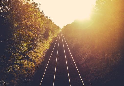 Train Tracks Stretching Into The Distance At Sunset