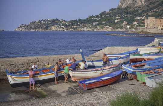 Boats moored at sunset in Porticello, Sicily