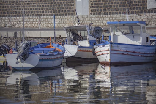 Boats moored at sunset in Porticello, Sicily