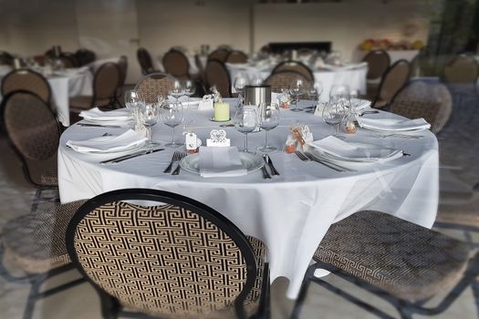 Festive table in a restaurant for a big family celebration with blurred background.