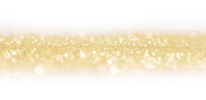 Golden festive glitter background with defocused lights , white copy space