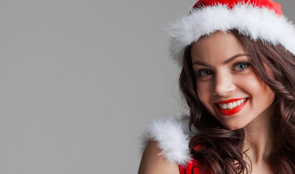 Beautiful happy woman in Santa Claus clothes