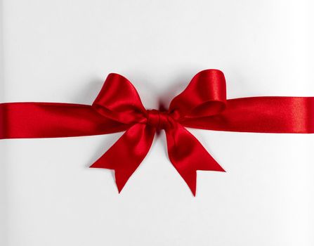Red gift bow isolated on white background
