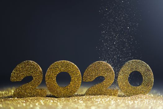 2020 New Year luxury design concept. Golden 2020 New Year horizontal template with golden glitter on blue backgound
