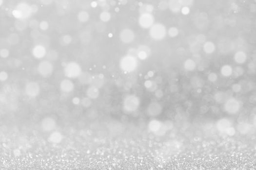 Shiny silver bokeh glitter lights abstract background, Christmas New Year party celebration concept