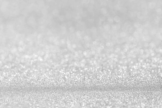 Shiny silver bokeh glitter lights abstract background, Christmas New Year party celebration concept