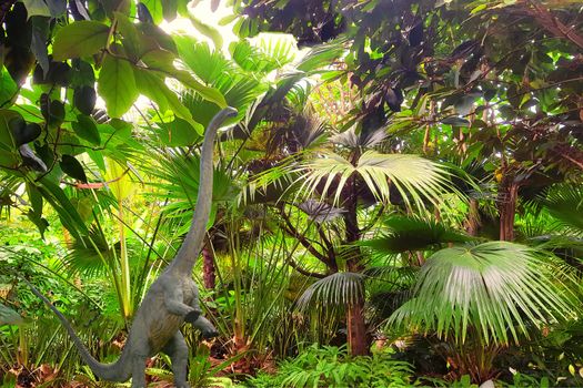 Big dinosaur long-neck. Close-up against the backdrop of a jungle