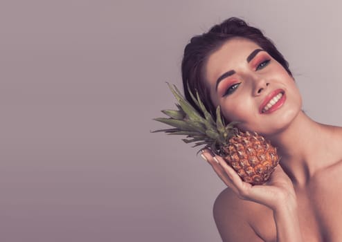 Woman with pineapple fruit smiling healthy and joyful