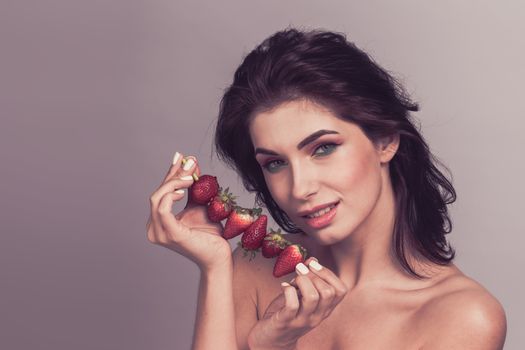 Woman with strawberry dessert fruit smiling healthy and joyful