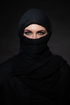 Portrait of beautiful muslim woman in black hijab