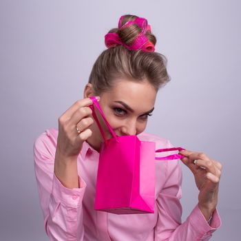 Shopping, sale, christmas and holiday concept - smiling woman with small shopping gift bag