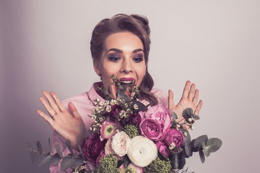 Woman surprised with bunch of flowers, funny emotional expression