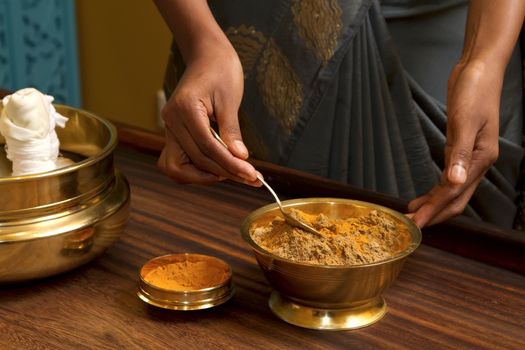  preparing herbs powder for  traditional indian ayurvedic  massage 