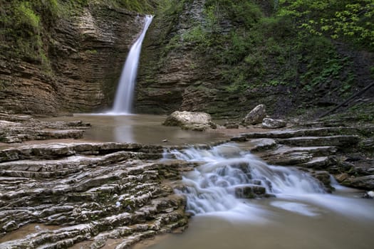   small cascade of waterfalls on a mountain river
