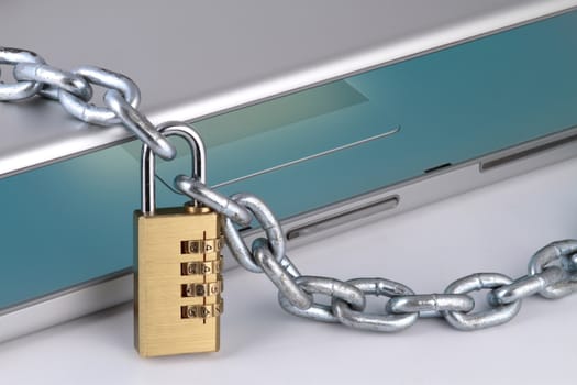notebook with chain and digital padlock, symbolizing internet security, close up fragment.