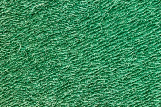 Texture of green towel fur. Concept of clothes or fashion.