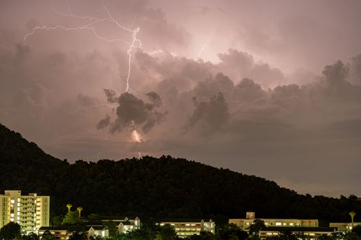 The Storm lightning strikes in mountains during a thunderstorm at night. Beautiful dramatic view