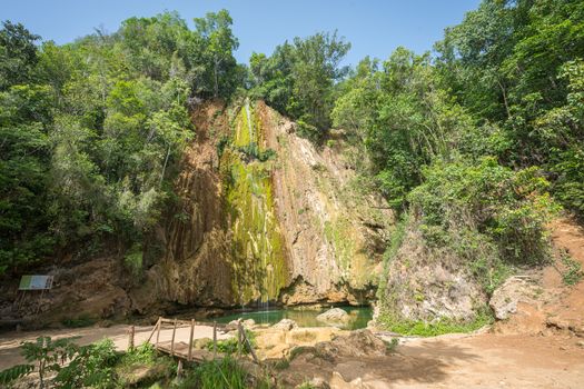 Panorama of the wonderful El Limon tropical waterfall with a lot of moss and steaming water, looks under the waterfall in the Dominican republic of the samana peninsula.