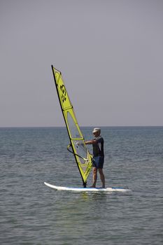 Windsurfing in the blue sea of Sardinia