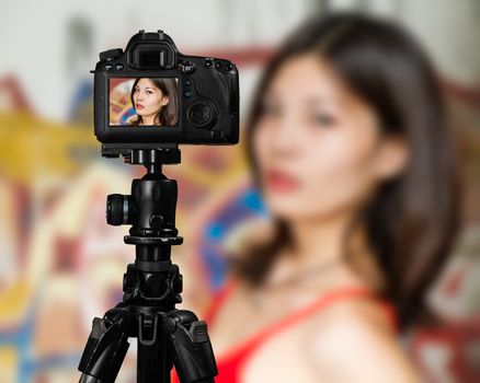 Taiwanese Chinese Vlogger posing for social media  photos, camera screen perspective