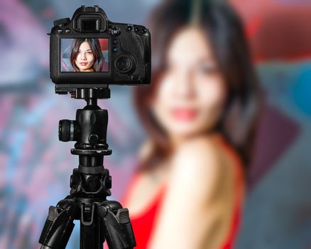 Taiwanese Chinese Vlogger posing for social media  photos, camera screen perspective