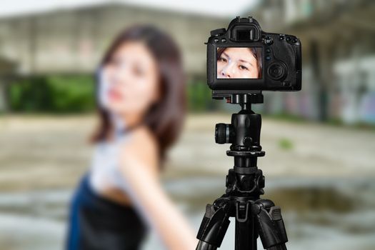 Taiwanese Chinese Vlogger posing for social media  photos viewed through back of camera