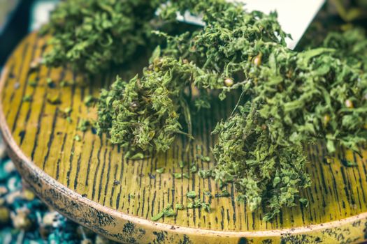 dried cannabis sativa closeup on a table .