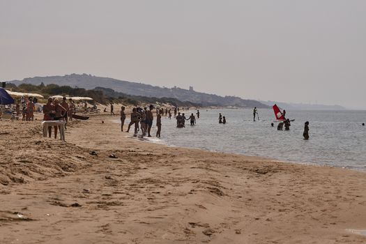 People walking on a beach in Marina di Butera, Sicily