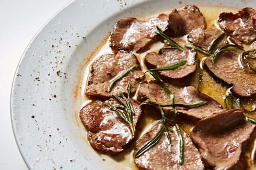 Fried beef tongue with coarse salt. Grilled beef tongue