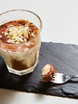 Tiramisu in glass, traditional coffee flavored Italian dessert made of ladyfingers and mascarpone