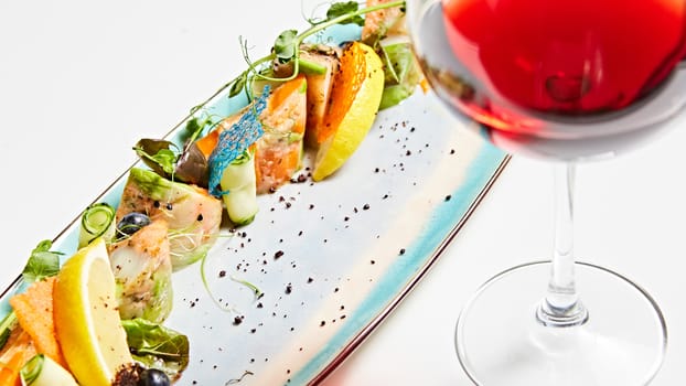 fried fish rolls with herbs and vegetables on blue plate