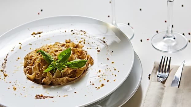 Tagliatelle with mushrooms and decorated with basil leaves