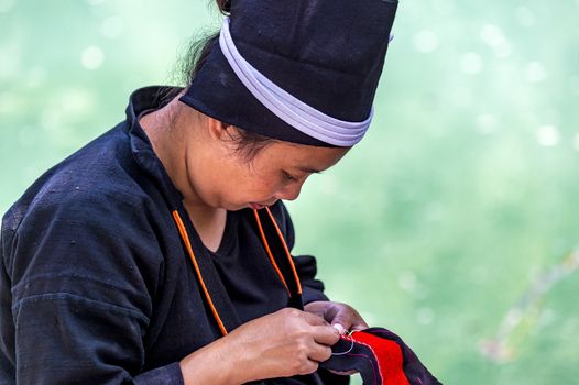 The Buyei women acts showing Bouyei women's diligence in weaving in Libo of Guangxi, China.