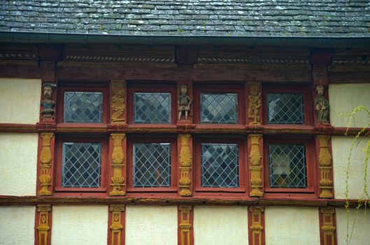 Windows and facade on medieval house in Dinon, France