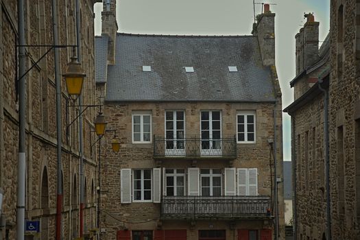 Old traditional French stone building district with wooden windows