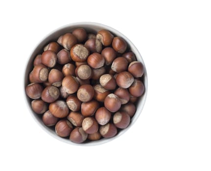 Full bowl of hazelnuts isolated on white background, top view.