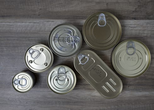 Tin cans for food on wooden background. Top View.