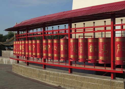 Prayer wheels at Buddhist temple Golden Abode of Buddha Shakyamuni. Russia, Elista, Kalmykia.