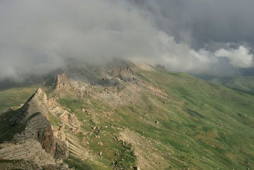 Rocky Mountains cliff and clouds fog. Nature landscape.