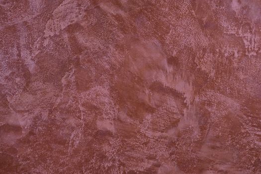 painted,  layered surface of the wall in magenta and red  tones