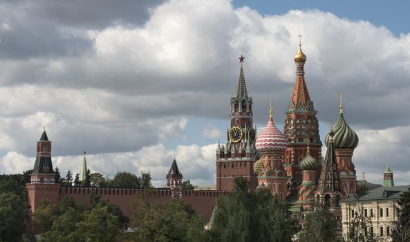 Moscow Russia View on Kremlin Towers and St. Basil Cathedral, on against cloudy sky.