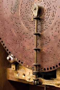  an ancient musical box, close up of disk with holes