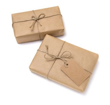 Christmas gift box wrapped in kraft paper. Isolated on white background