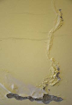 The photo represents a wall peeling with plaster to be removed