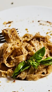 Tagliatelle with mushrooms and decorated with basil leaves