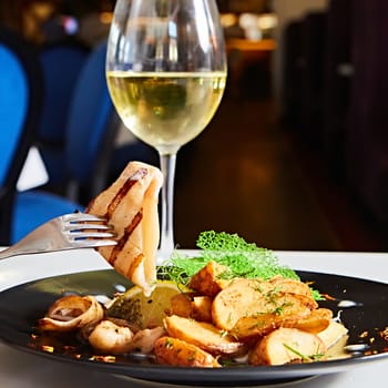 Grilled squid with salad. Shallow dof