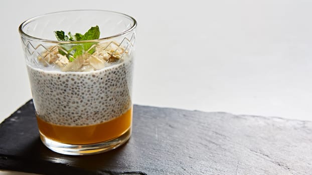 Mango yogurt with chia seeds for healthy brekfast on a white background, copy space