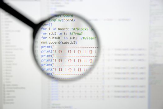 Real Python code developing screen. Programing workflow abstract algorithm concept. Lines of Python code visible under magnifying lens.
